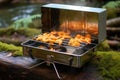 shrimp grilling on a portable camping stove Royalty Free Stock Photo