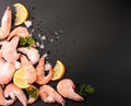 Shrimp with ice, lemon and parsley on a dark background. Copy space, the view from top Royalty Free Stock Photo