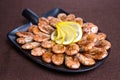 shrimp with lemon on a stylish black plate in a restaurant