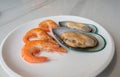 Shrimp and mussel Placed on a white plate. On a white marble table Royalty Free Stock Photo