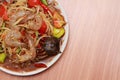 Shrimp papaya salad is delicious food of somtum thaifood on wood.