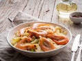 Shrimp, pasta tagliatelle, green peas, dill. White plate on old rustic wooden table, side view, copy space Royalty Free Stock Photo