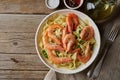 Shrimp, pasta tagliatelle, green peas, dill. White plate on old rustic wooden table, top view, copy space Royalty Free Stock Photo