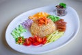 Shrimp paste fried rice is served with sweet pork, sliced fried egg, fried dry shrimp and Thai sausage, chopped red onion, chili Royalty Free Stock Photo