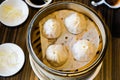 4 shrimp and pork Chinese dumplings know as Xaio Long Bao in hot bamboo tray