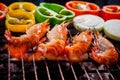 Shrimp,prawns grilled on barbecue fire stove with chilly onion f Royalty Free Stock Photo