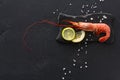 Shrimp with salt and lemon on black background Royalty Free Stock Photo