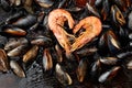 Shrimp in the shape of a heart on background of mussels Royalty Free Stock Photo