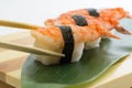 Shrimp sushi nigiri on wooden plate isolated on white background Royalty Free Stock Photo