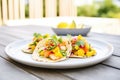 shrimp tacos with mango salsa in a bright outdoor setting