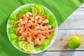 Shrimp tails on bed of lettuce and lemon sllices Royalty Free Stock Photo