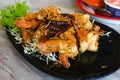 Fried shrimp with tamarind sauce thailand seafood. Sweet and sour tasty food. decorative with vegetable and red hot chilli on blac