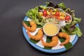 Shrimp tempura and salad of fresh vegetables close-up on a plate on black background. horizontal view from above Royalty Free Stock Photo