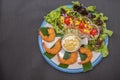 Shrimp tempura and salad of fresh vegetables close-up on a plate on black background. horizontal view from above Royalty Free Stock Photo