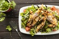 Shrimp vegetable salad in batter on a dark wooden table, oriental and asian cuisine