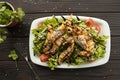 Shrimp vegetable salad in batter on a dark wooden table, oriental and asian cuisine