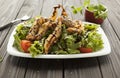 Shrimp vegetable salad in batter on a dark wooden table, oriental and asian cuisine