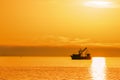 Shrimping boat at sunset on ocean Royalty Free Stock Photo