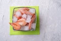 Shrimps in bowl with ice at green napking. served at white table Royalty Free Stock Photo