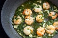 Shrimps with herbs and garlic oil are fried in a pan, cooking seafood concept, selected focus Royalty Free Stock Photo