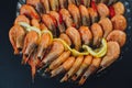 Shrimps with lemon and black pepper on dark background Royalty Free Stock Photo
