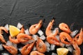 Shrimps, lemon and ice on background, top view