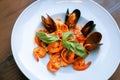 Tasty pasta with shrimps and mussels standing on the table