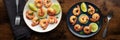 Shrimps panorama. Cooked shrimp, two plates, overhead flat lay shot