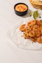 Shrimps on parchment paper with sauce and lime on white background Royalty Free Stock Photo