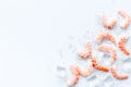 Shrimps - peeled, with ice - on white table frame space for text