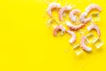 Shrimps - peeled, with ice - on yellow background frame space for text