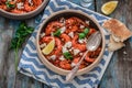 Shrimps saganaki with feta cheese on a plate on a table Royalty Free Stock Photo