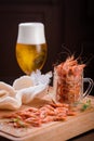 Shrimps on a wooden board end glass of beer Royalty Free Stock Photo