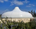 Shrine of the Book in Jerusalem white tiled roof with water sprinklers and blue sky