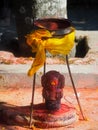 Shrine covered in vermillion to worship Goddess Kali. Red pigment powder on statue in Dhulikhel, Nepal Royalty Free Stock Photo