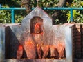 Shrine covered in vermillion to worship Goddess Kali. Red pigment powder on stone, Kali Shrine in Dhulikhel, Nepal Royalty Free Stock Photo