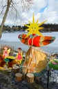 Shrovetide doll in bright multi-colored dress with face-sun