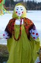Shrovetide doll in colorful headscarf and sarafan