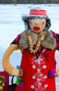 Shrovetide doll in red sundress with embroidery and colorful shawl