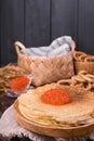 Shrovetide Maslenitsa Week festival meal. Stack of russian pancakes with red caviar. Rustic style, free space for text Royalty Free Stock Photo