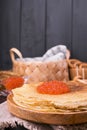 Shrovetide Maslenitsa Week festival meal. Stack of russian pancakes with red caviar. Rustic style, free space for text. Royalty Free Stock Photo