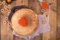 Shrovetide Maslenitsa Week festival meal. Stack of russian pancakes with red caviar. Rustic style, free space for text Royalty Free Stock Photo