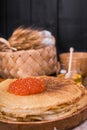 Shrovetide Maslenitsa Week festival meal. Stack of russian pancakes with red caviar. Rustic style, free space for text. Royalty Free Stock Photo