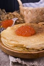 Shrovetide Maslenitsa Week festival meal. Stack of russian pancakes with red caviar. Rustic style, free space for text Royalty Free Stock Photo