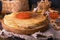 Shrovetide Maslenitsa Week festival meal. Stack of russian pancakes with red caviar. Rustic style, free space for text Royalty Free Stock Photo