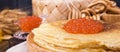 Shrovetide Maslenitsa Week festival meal. Stack of russian pancakes with red caviar. Rustic style, free space for text Royalty Free Stock Photo