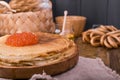 Shrovetide Maslenitsa Week festival meal. Stack of russian pancakes with red caviar. Rustic style, free space for text Royalty Free Stock Photo