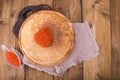 Shrovetide Maslenitsa Week festival meal. Stack of russian pancakes with red caviar. Rustic style, free space for text Royalty Free Stock Photo