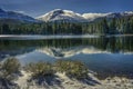 Shrubs and Lassen Peak after snow storm with reflections in Manzanita Lake, Lassen Volcanic National Park Royalty Free Stock Photo