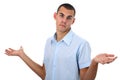 Shrugging young man in blue shirt isolated Royalty Free Stock Photo